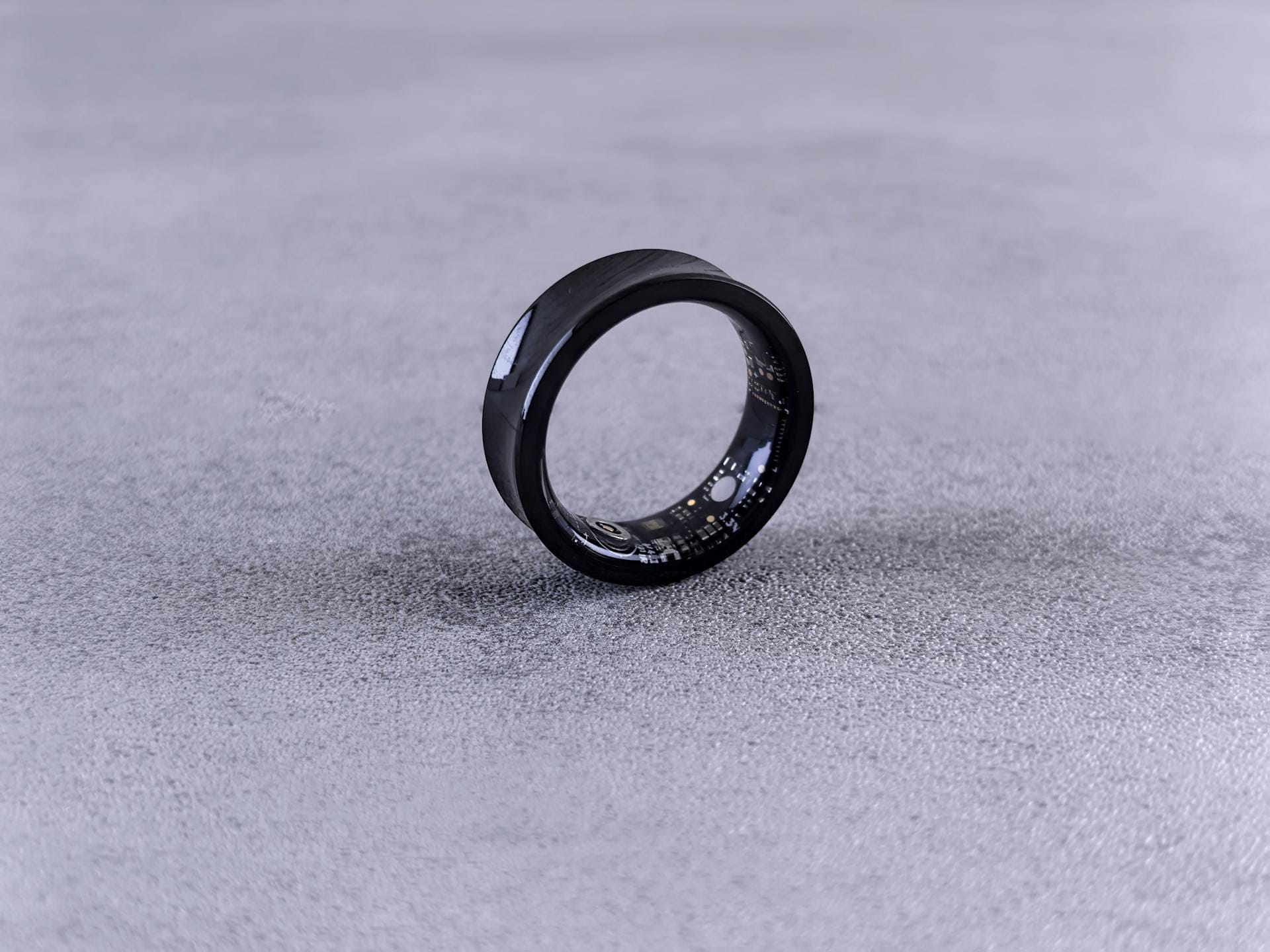 Smart ring on finger showing health data