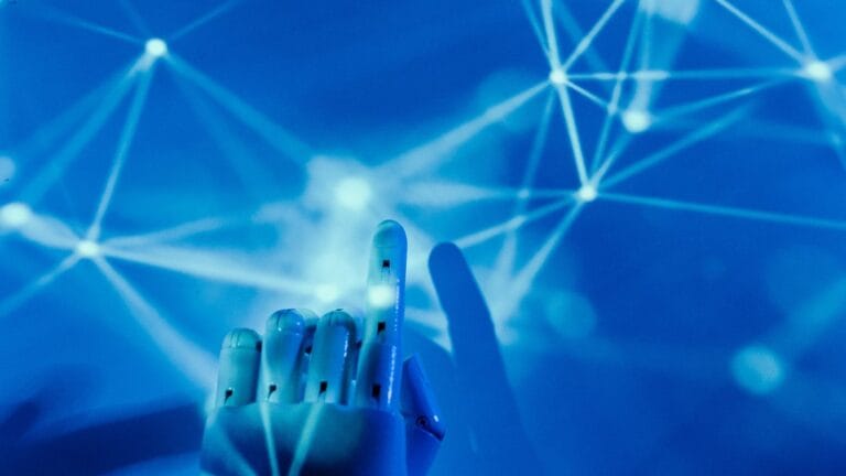 A robotic hand reaching toward a glowing blue AI neural network